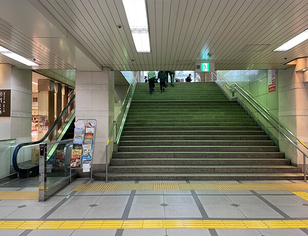 改札を出て目の前の階段を上がり、右に曲がります。